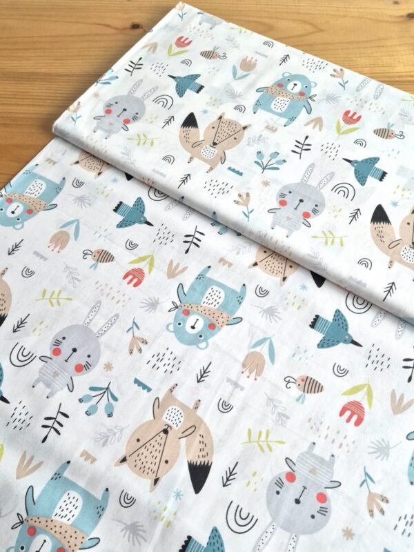 Tela sarga con estampado de osos y animales en tonos pastel vista en ángulo de 45 grados