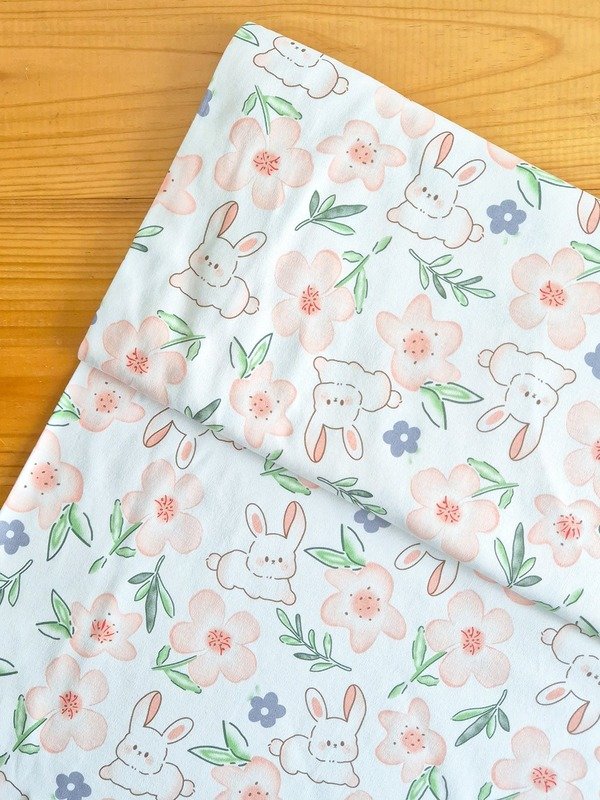 Tela Interlock Conejos y Flores Naranja