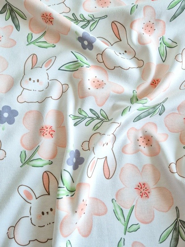 Tela Interlock Conejos y Flores Naranja